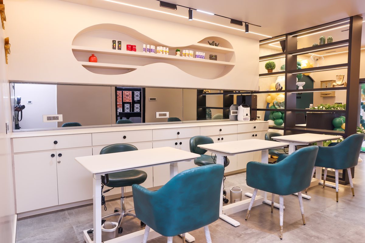 Inside Based Aesthetics — manicure tables and teal chairs in the Kilpauk studio